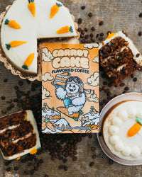 Carrot cake-flavored coffee package with a slice of carrot cake and coffee on a rustic surface.