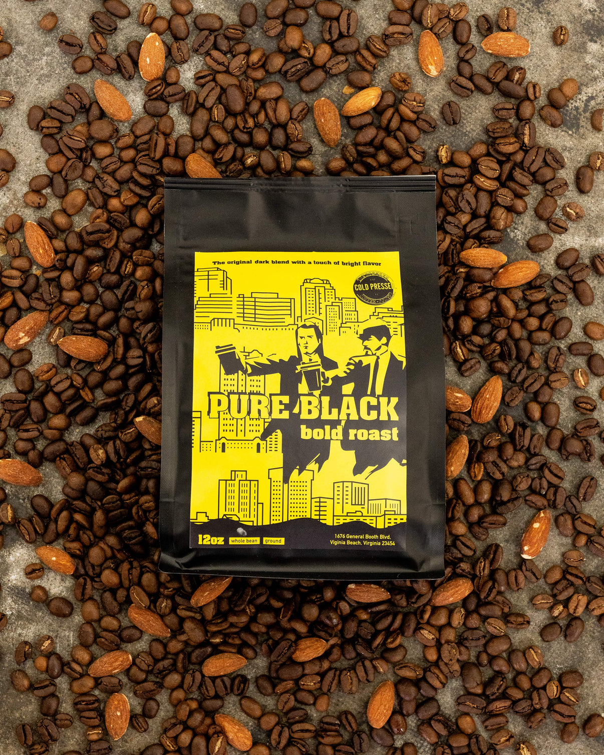 Coffee bag labeled 'Pure Black Bold Roast' surrounded by coffee beans on a textured surface.